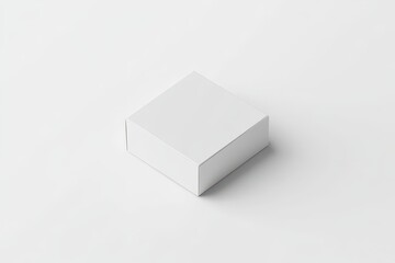 Blank, square, white cardboard box on a plain surface.