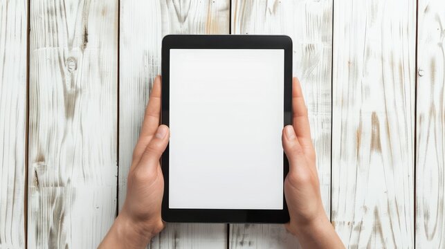 Showcase a close-up of hands holding a tablet device with a blank white screen, perfect for adding custom content or branding related to digital work, creativity, or productivity