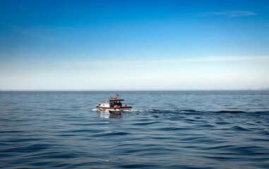 small fishing boat sailing on the sea.	