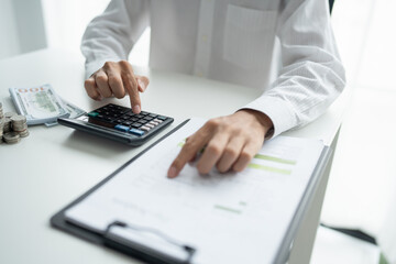 Businessman checking bills taxes bank account balance and calculating annual financial statements of company. Accounting Audit Concept