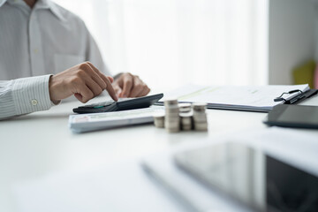 Fototapeta premium Businessman checking bills taxes bank account balance and calculating annual financial statements of company. Accounting Audit Concept