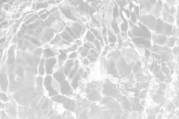 White water with ripples on the surface. Defocus blurred transparent white colored clear calm water surface texture with splashes and bubbles. Water waves with shining pattern texture background.