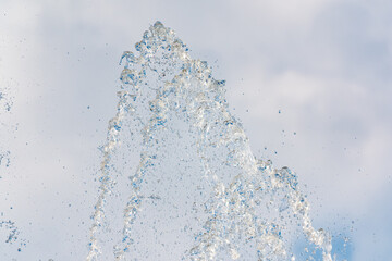 Splashes and jets of water against light background.