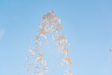 Splashes and jets of water against light background.