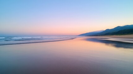 Obraz premium Serene Beach Sunset Coastal Landscape with Calm Ocean Waves and Mountain Silhouette at Dawn