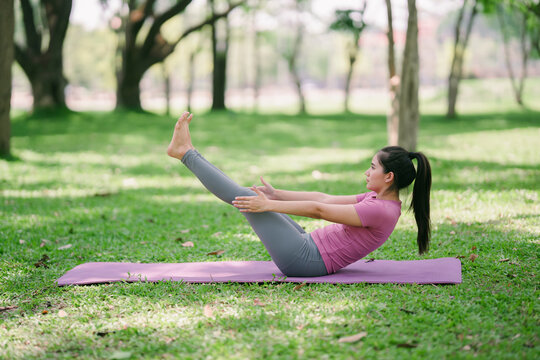 Beautiful Asian woman practicing Matsyasana yoga pose