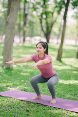 Beautiful Asian woman practices yoga for health, concentration and strength.