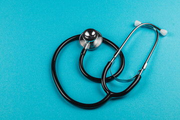 Stethoscope resting on a teal background