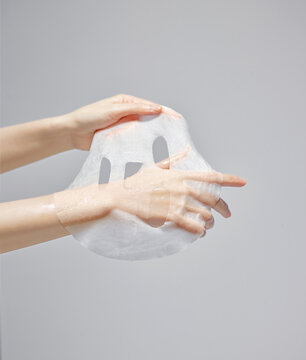 A woman's hand on a mask sheet
