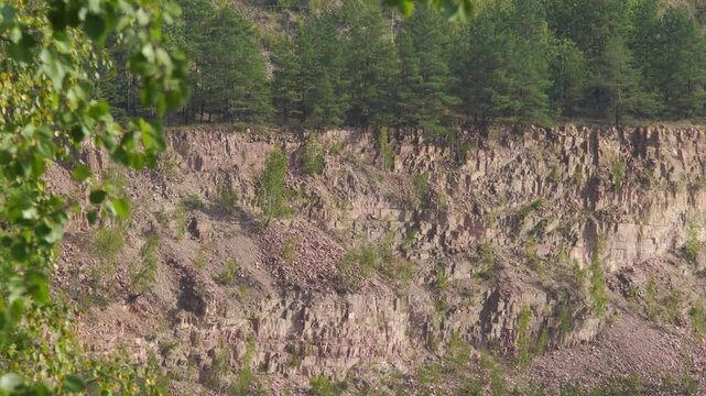 Rocky slope of a quartzite quarry view through trembling air
