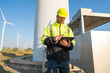 Engineer wearing uniform inspection and survey work in wind turbine farms rotation to generate...