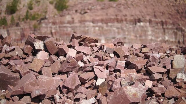 Pile of quartzite stones fragnets close-up truck shot in a quarry
