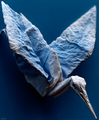 A perfectly folded paper crane floating in midair against a solid pastel blue background. Minimalist origami elegance.

