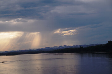 Sunset painted the clouds over the calm river and lake with a panoramic reflection of the colorful sky