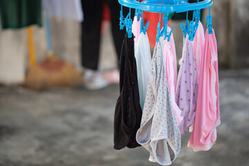 Washed underwear hanging on clothesline with blue clothespin and blurred background.soft picture, selective focus