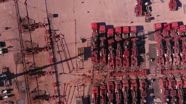 A drone takes panning of a fracking site in Vaca Muerta, Argentina. Trucks with ultra-high-pressure engines break up the rock to extract gas and oil.