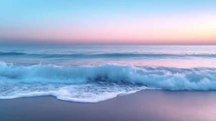 Fototapeta premium Ocean waves gently lap at the sandy shore during sunset hues