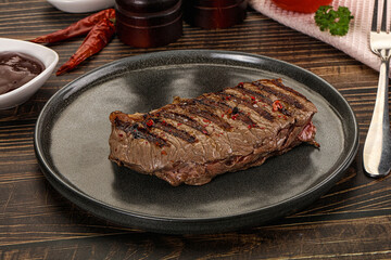Grilled beef striploin steak with sauce