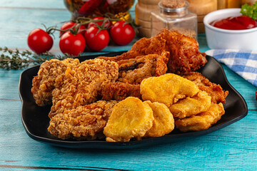 Golden crispy fried chicken mix - wings, drumsticks, nuggets and strips