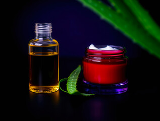Aloe vera gel and oil in glass bottles on a dark background with natural lighting and copy space for