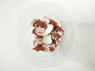 Isolated white background of broken egg shells in a bowl