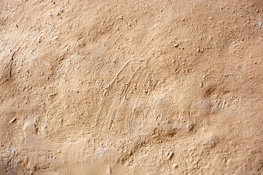 Soil wall texture of clay house structure with light and shadow. Mud background.