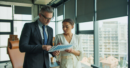 Business partners analyze financial data together
