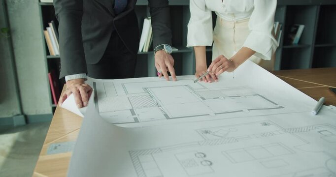 Businesspeople analyzing architectural drawings. 4k video