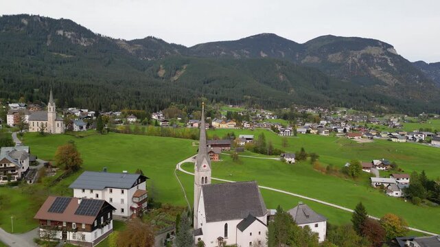 Aerial view of tall historic churchs in scenic Gosau village in Austria.