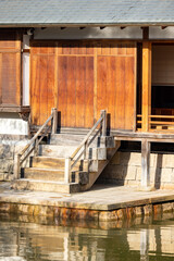 Obraz premium Rustic wooden steps gracefully leading to a serene water view, beautifully showcasing traditional architectural design