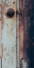 close up of rustic door knob on wooden door with paint peeling and rust showing grunge backdrop background of household metal door knob on old weathered wooden exterior door vertical image type space