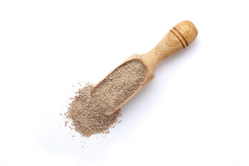 Top view of a wooden scoop filled with Organic White Pepper (Piper nigrum) powder. Isolated on a white background.