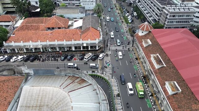 A T-junction in the middle of the bandung city, located on a busy provincial road, recorded by a drone.