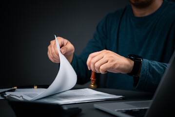 Man stamping official document. Legal contract approval and certified business paperwork.Signature...