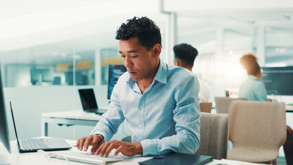 Programmer, man and typing on computer in office for software development, code debugging and...