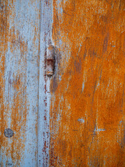 Rusty metal texture on weathered wooden door panel