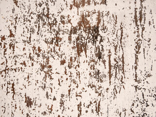 Rustic weathered wall texture with peeling paint and rust streaks