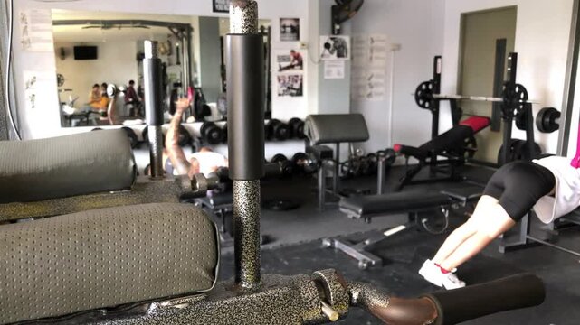 Young people working out inside the gym. Blurs