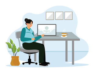 Pregnant woman working on laptop at home.