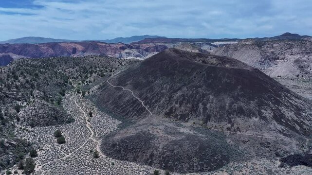 Aerial volcano cinder cone mountain St George Utah overhead 1. Southwestern desert mountains landscape. Geological wind, weather and water carved erosion. Hiking trails and nature travel. Environment.