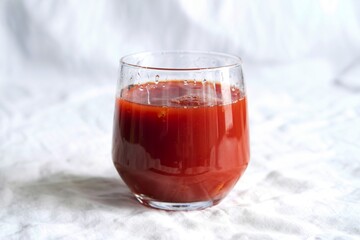 a tall glass of vibrant red tomato juice