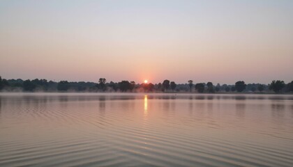 Fototapeta premium Serene sunset reflecting on calm water surface.