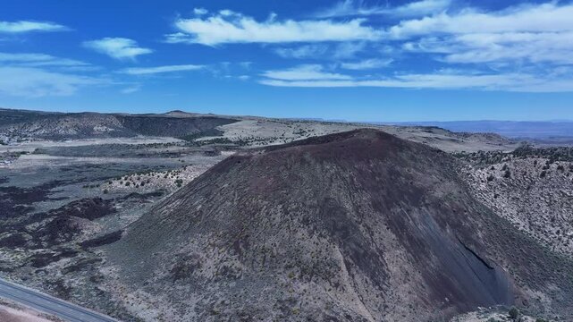 Aerial volcano cinder cone mountain St George Utah circle 3. Southwestern desert mountains landscape. Geological wind, weather and water carved erosion. Hiking trails and nature travel. Environment.