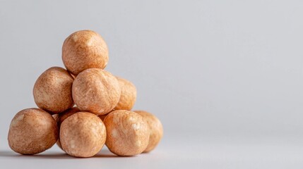 Macro photo of round hazelnuts, earthy shells against pure white, natural snacks