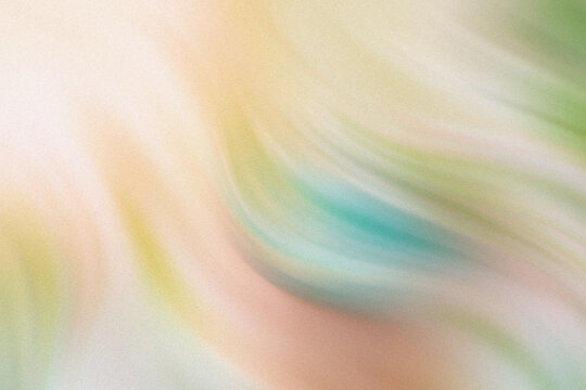 A blurry abstract image with hints of green yellow and white creating a soft and dreamy composition effect