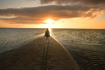 Profile young girl on beach at sunset Cape Hatteras National Sea