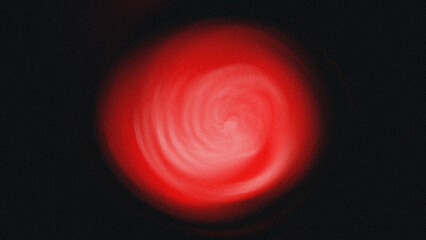 A blurry red light glows brightly against a dark background creating an abstract and soft illumination