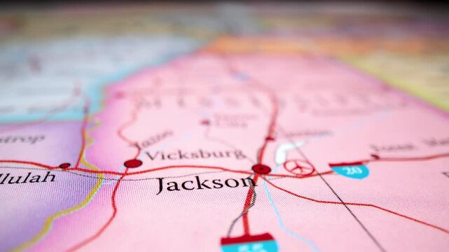 Closeup Of Fabric-textured Map Highlighting Jackson And Vicksburg In Mississippi. rack focus, revealing shot