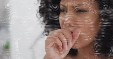 Woman pressing hand to mouth, displaying health concern with digital dotted mesh overlay - Powered by Adobe