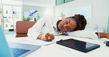 Bored, black woman and writing with fatigue for burnout, stress or insomnia at office desk. Tired,...